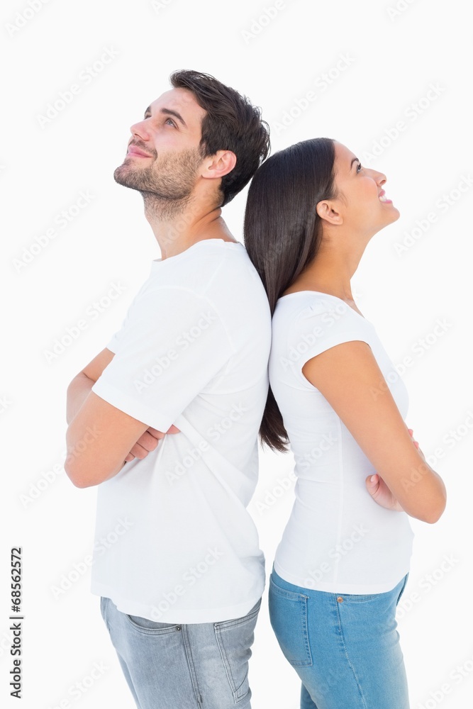 Happy couple standing looking up Happy couple standing looking up