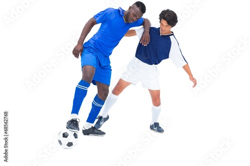 Football players tackling for the ball © WavebreakmediaMicro