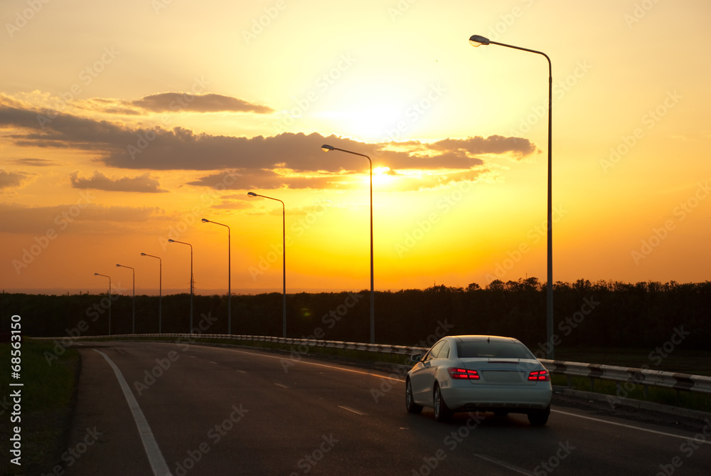 car driving on the highway at sunset
