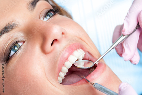 Dentist working on girls teeth
