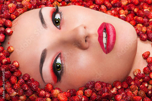 Beautiful female face in wild strawberry