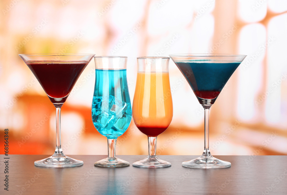 Several glasses of different drinks on bright background Several glasses of different drinks on bright background