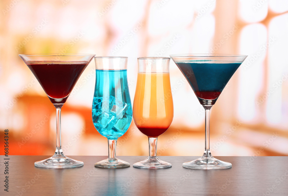 Several glasses of different drinks on bright background