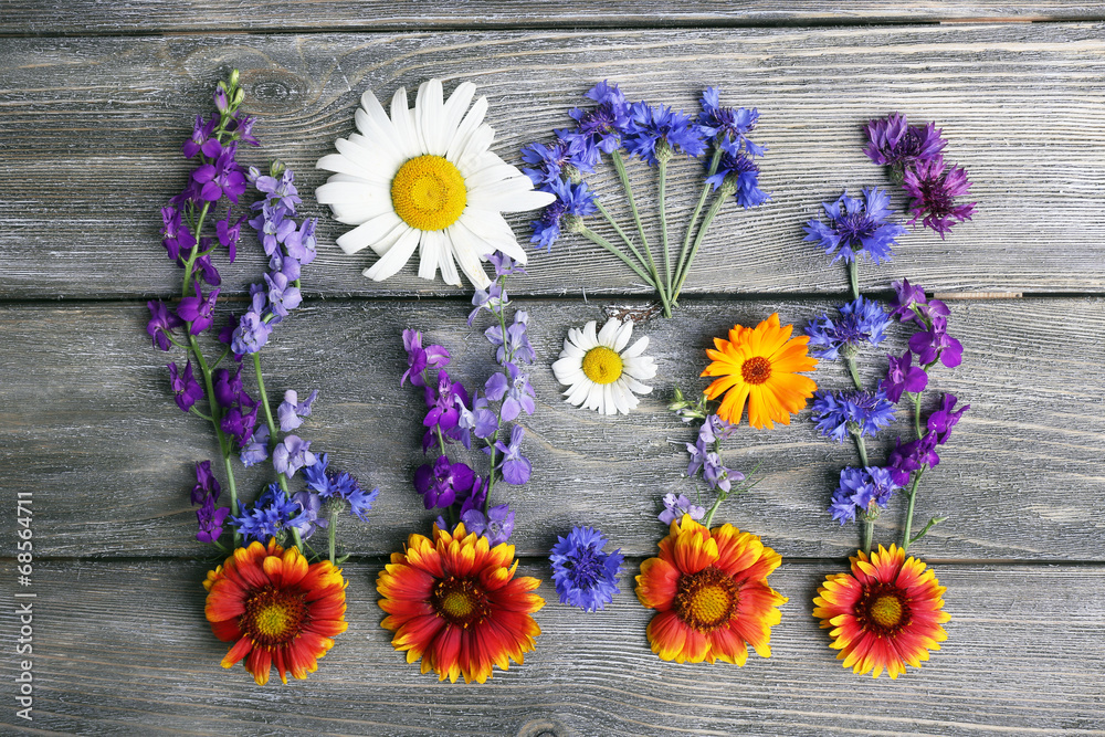 Beautiful wildflowers on wooden background Beautiful wildflowers on wooden background