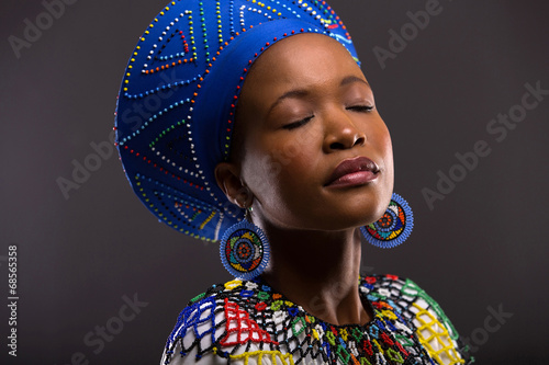 Obraz na plátně black woman in traditional clothes with eyes closed