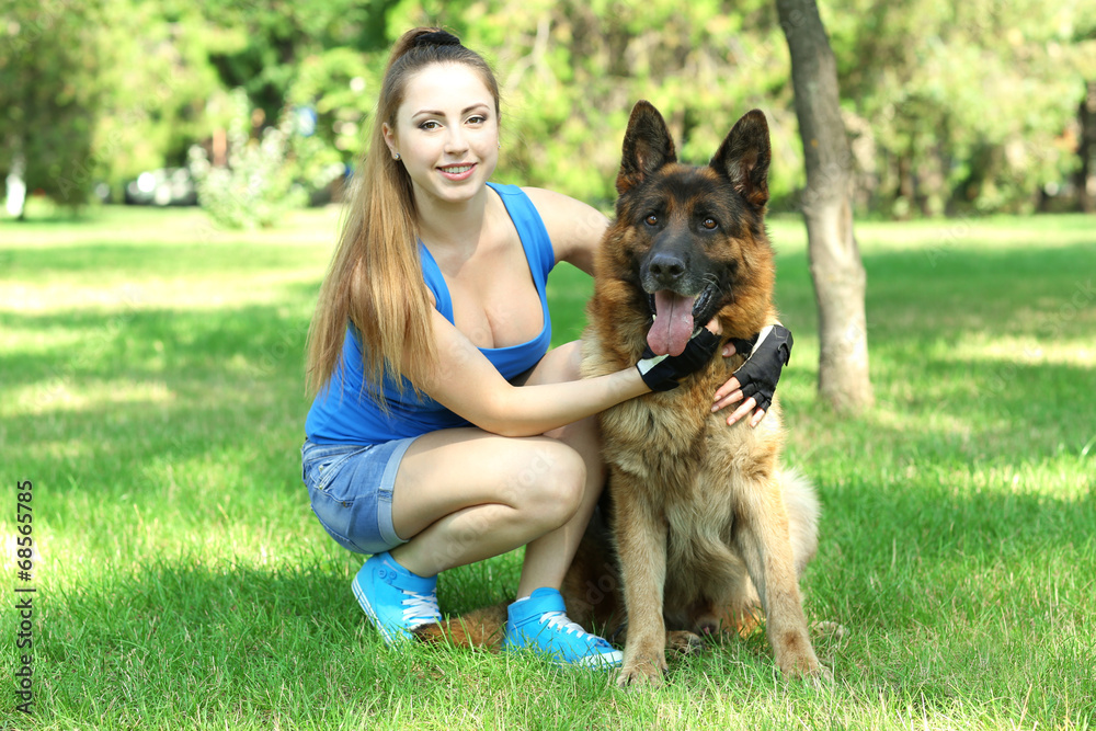 Beautiful young girl with dog in park Beautiful young girl with dog in park