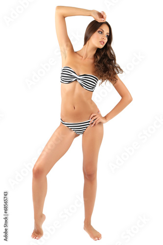 Beautiful young woman in striped swimsuit isolated on white