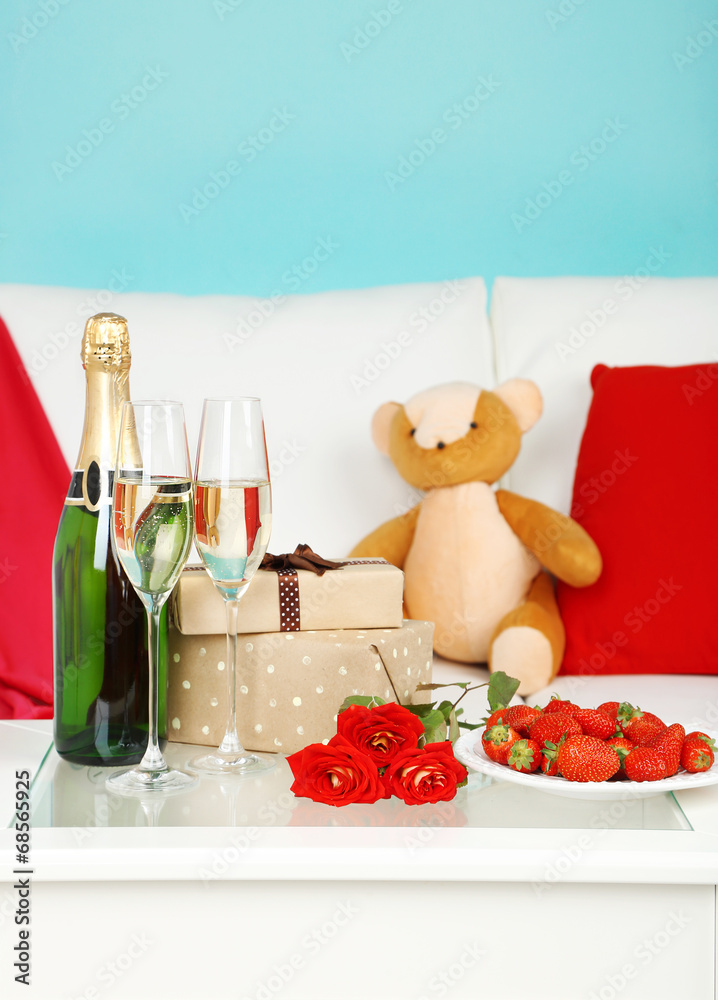 Romantic still life with champagne, strawberry and roses in