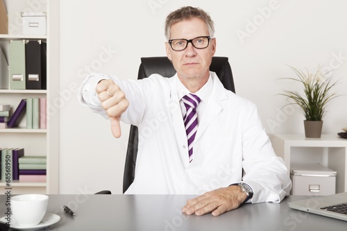 Sad Male Doctor Showing Thumbs Down