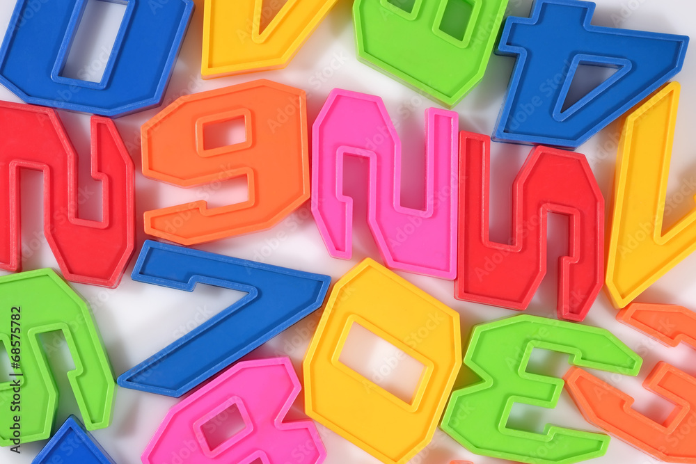 Colorful plastic numbers close up on a white Colorful plastic numbers close up on a white