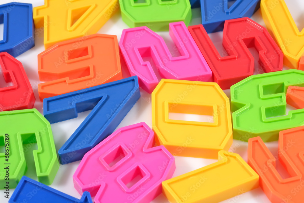 Fototapeta premium Colorful plastic numbers close up on a white