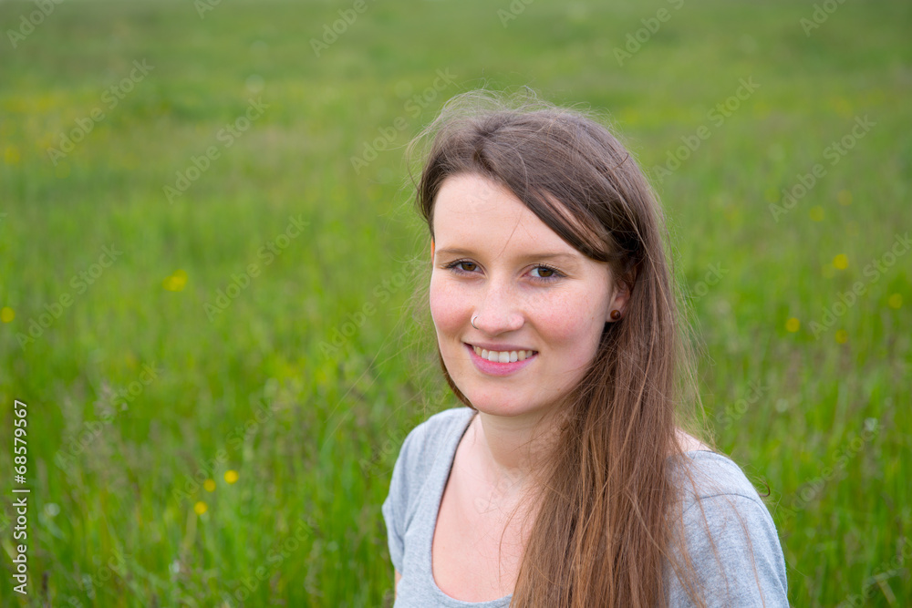 brunette haired young woman in front of nature background brunette haired young woman in front of nature background