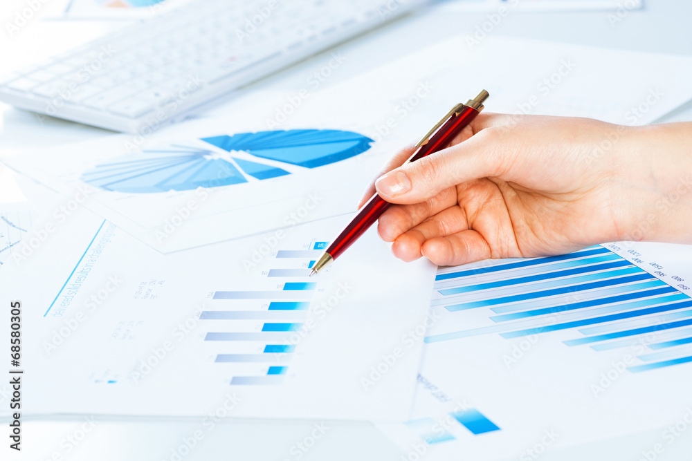 female hand pointing to the financial growth chart female hand pointing to the financial growth chart