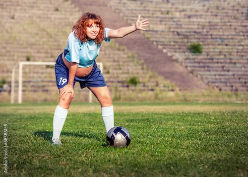 Active pregnant woman playing football © Soloviova Liudmyla