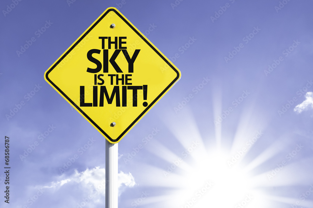 The Sky Is The Limit road sign with sun background