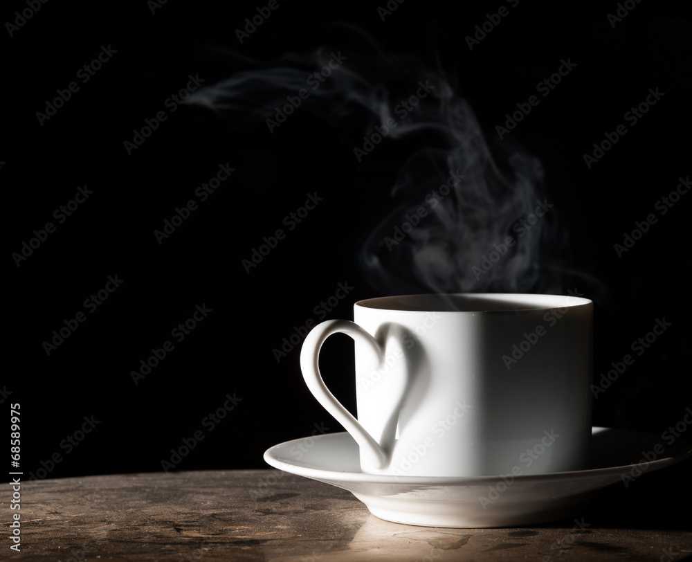 Coffee love. Warm cup of coffee on black background