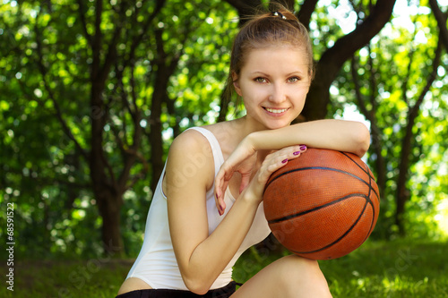 beautiful girl with a smile with a basketball ball in for sports