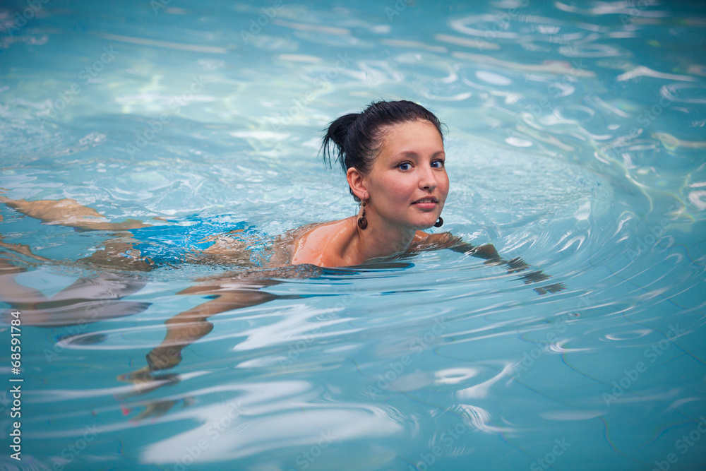 brunette girl in blue swimming suit