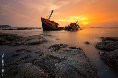 Fishing boat beached with sunset view