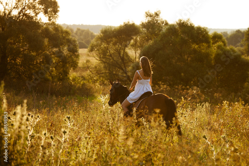 Young woman on a brown horse © dimedrol68