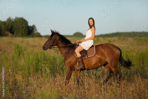 Girl in white dress on a horse