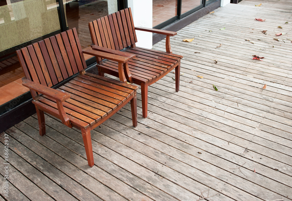 Adirondack wood chairs on a cabin porch Adirondack wood chairs on a cabin porch