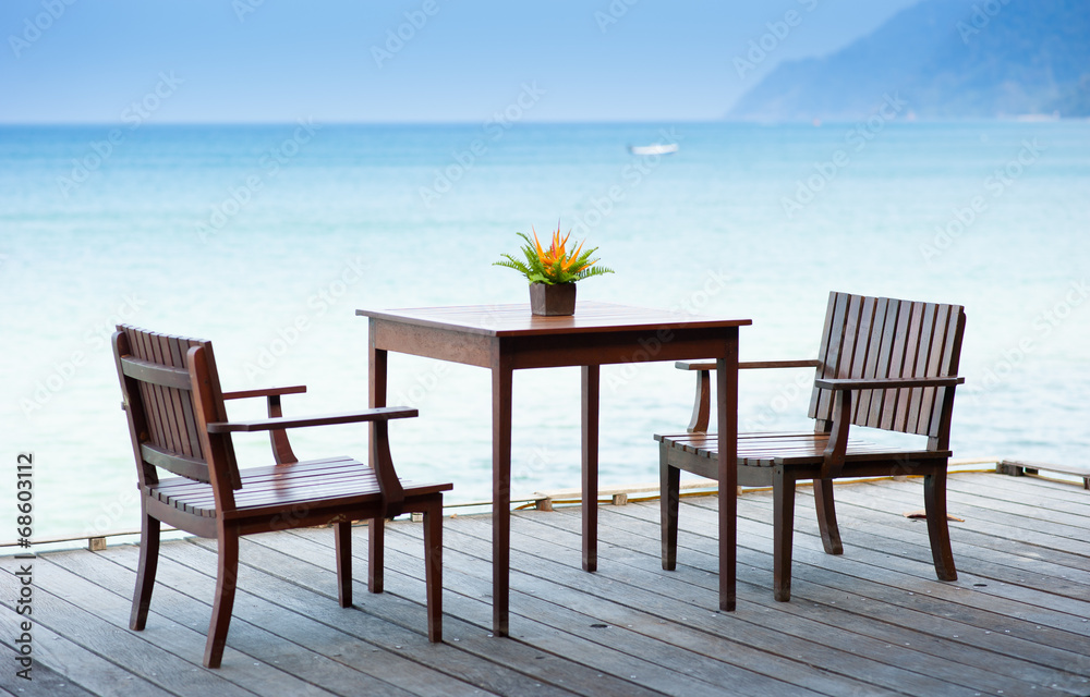 Terrace sea view with outdoor wood chairs and table