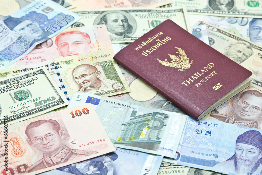Thailand passport on mixed currency banknotes Thailand passport on mixed currency banknotes