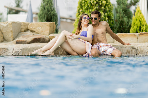 Young couple by the pool © BGStock72