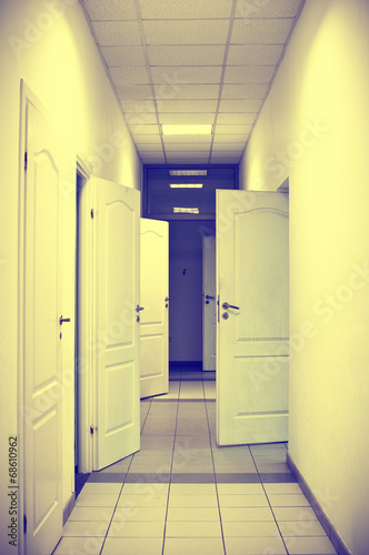 corridor with many doors open