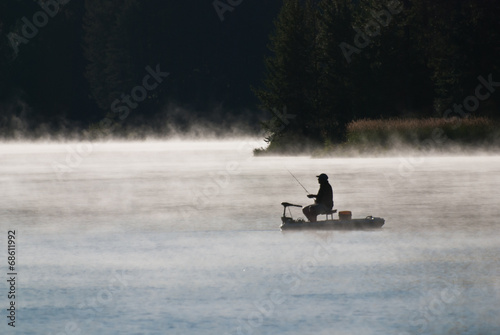 Silhouette of Fisherman in Early Morning Mist