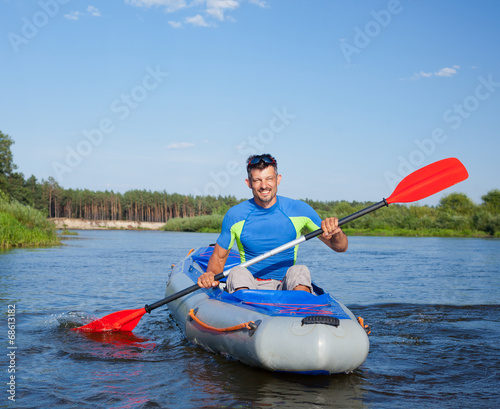 Quadro em tela Young man kayaking