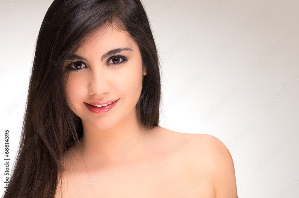 Closeup portrait of beautiful young brunette girl posing