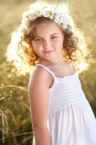 portrait of a beautiful little girl in a field