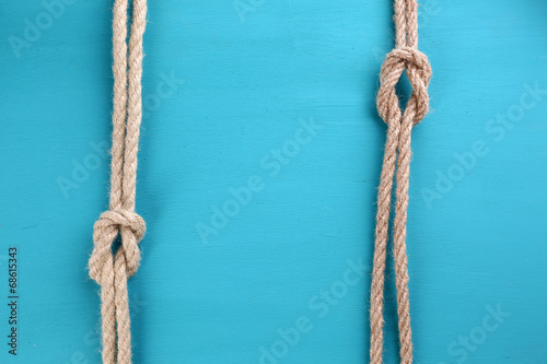 Marine knots on color wooden background