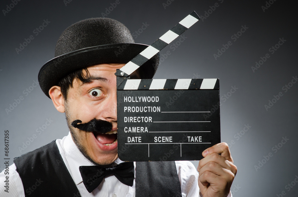 Funny man with movie clapper board Funny man with movie clapper board