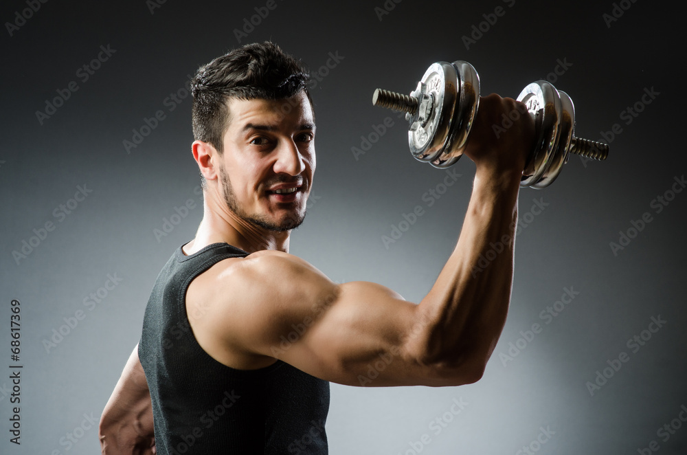 Muscular ripped bodybuilder with dumbbells