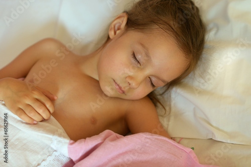 Cute girl sleeping in bed