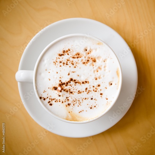 cup of cappucchino over wooden table