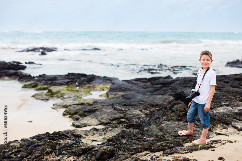 Little boy at rocky coast