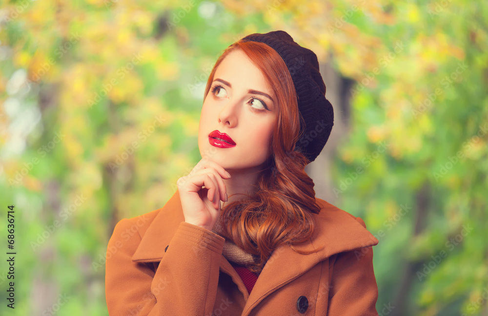 Redhead girl in autumn park Redhead girl in autumn park