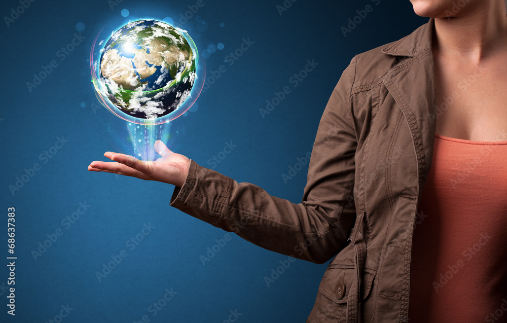 Woman holding glowing earth globe Woman holding glowing earth globe