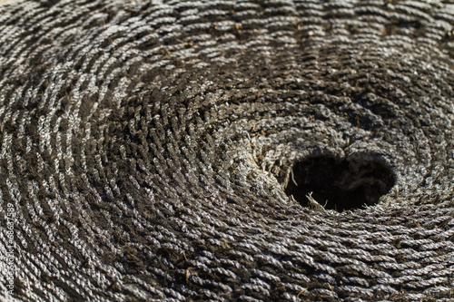 Close view of an old and weathered concentric wicker material.