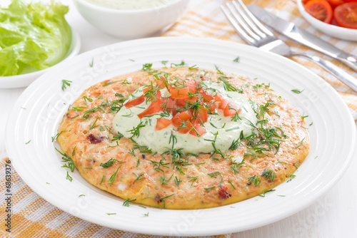 dietary omelette with carrot and green yogurt sauce on a plate