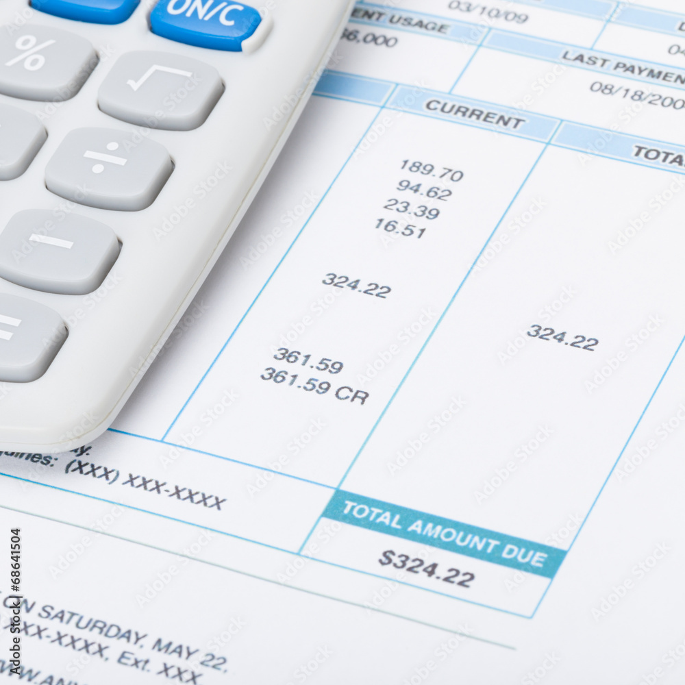 Receipt next to calculator over it - studio shot - 1 to 1 ratio Receipt next to calculator over it - studio shot - 1 to 1 ratio