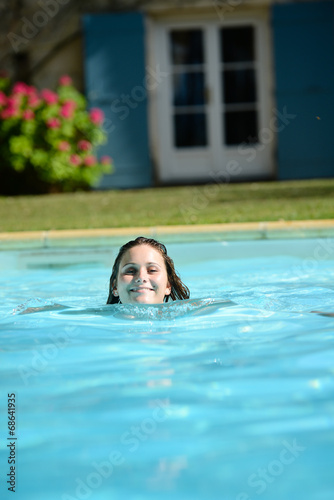 cheerful young woman in resort swimming pool summer vacations