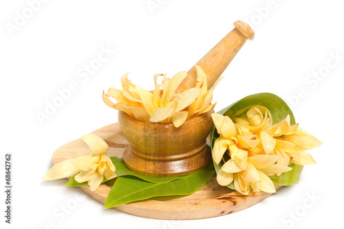 Mortar and pestle with champaka flower decoration for spa aromat photo