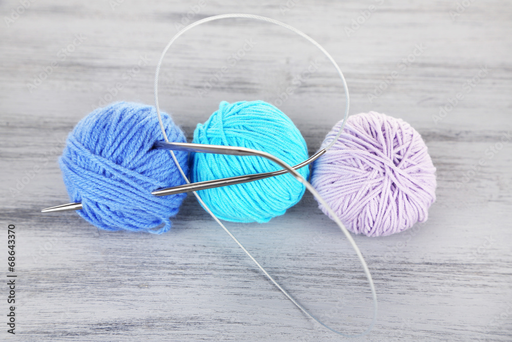 Balls of wool on wooden table background