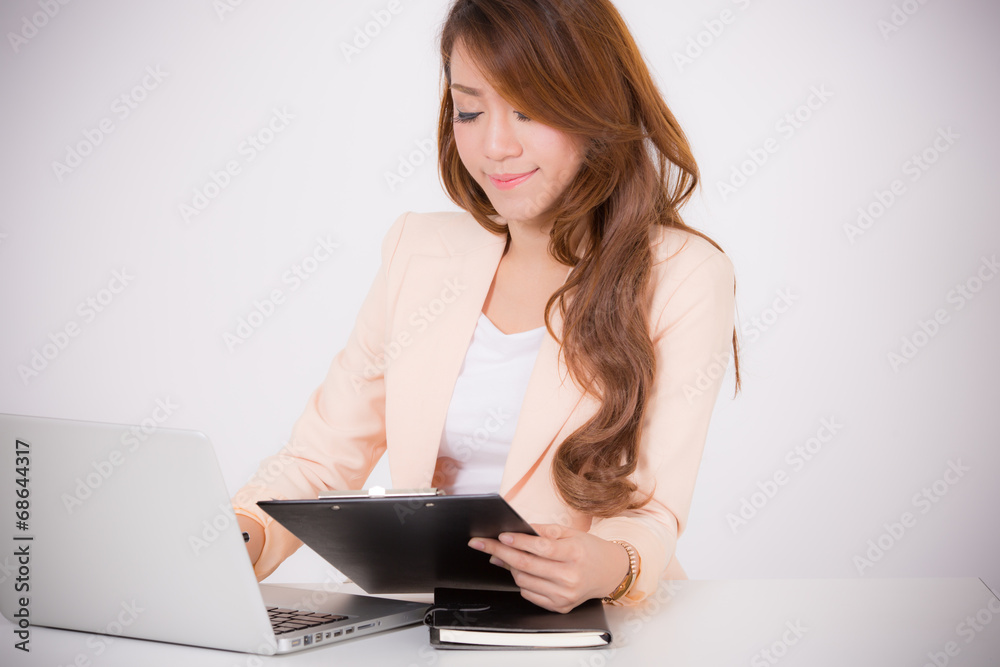 Portrait of a young business woman using laptop at office Portrait of a young business woman using laptop at office