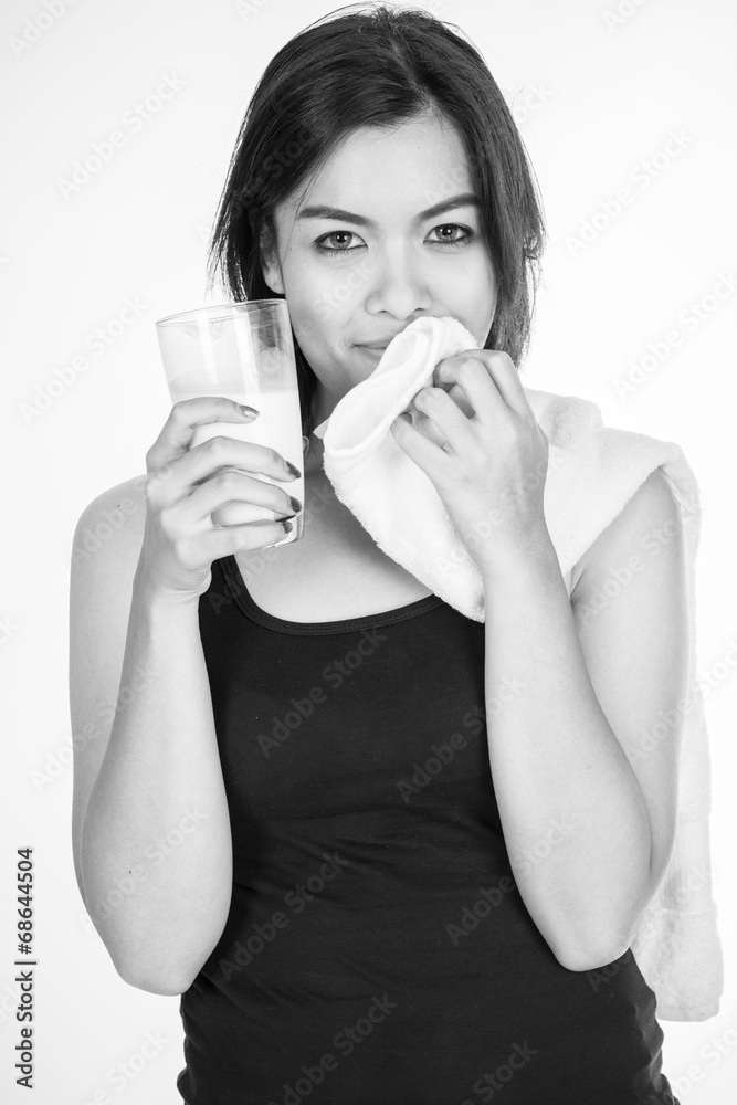 Laughing young woman with a glass of milk